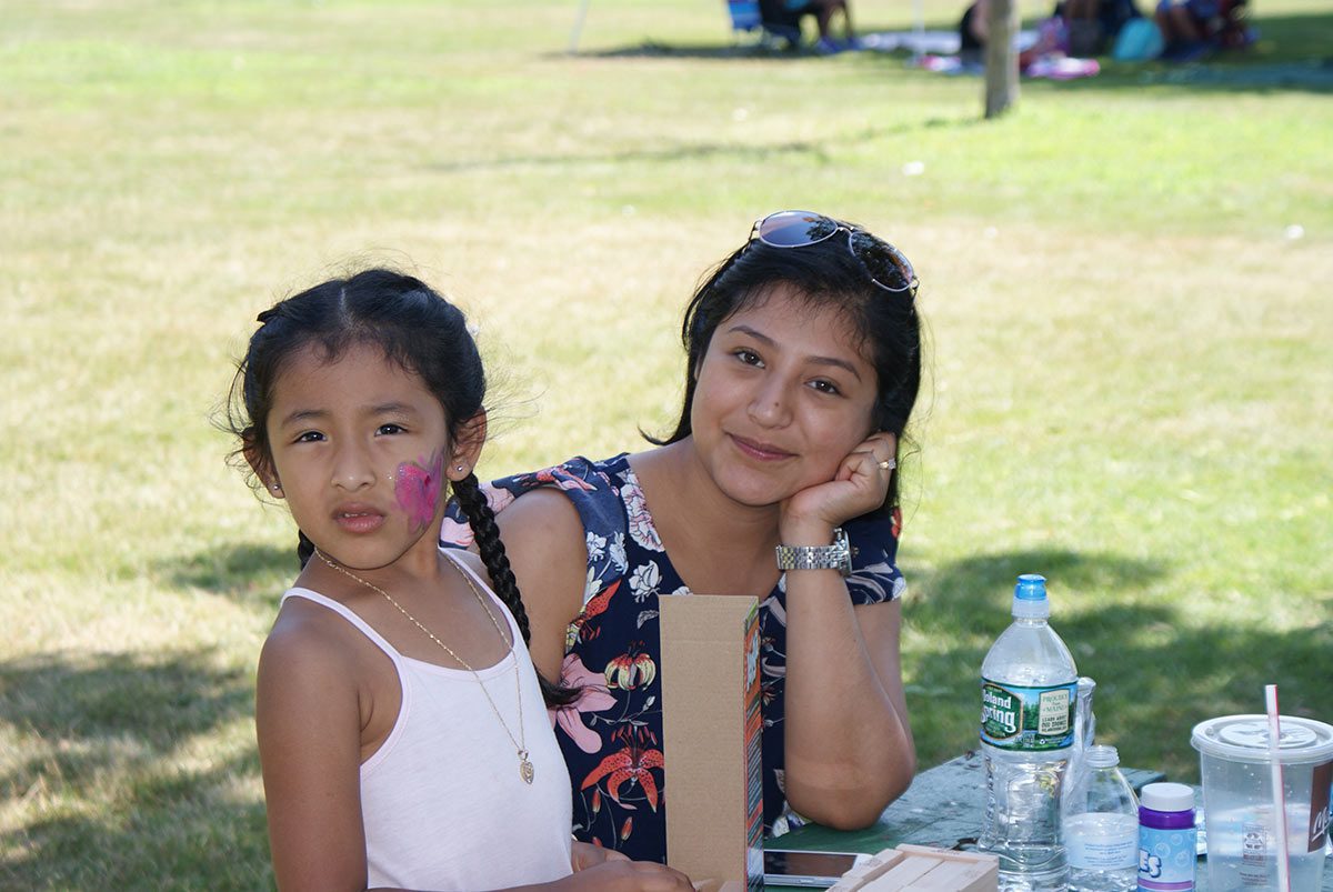 mother and daughter sitting at a picnic table